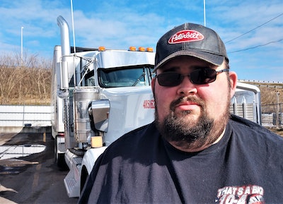 Scott Reed standing in front of his 2019 Kenworth