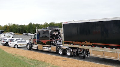 Rear view of John Highley's 2018 Kenworth W900L with Harley-Davidson motorcycle